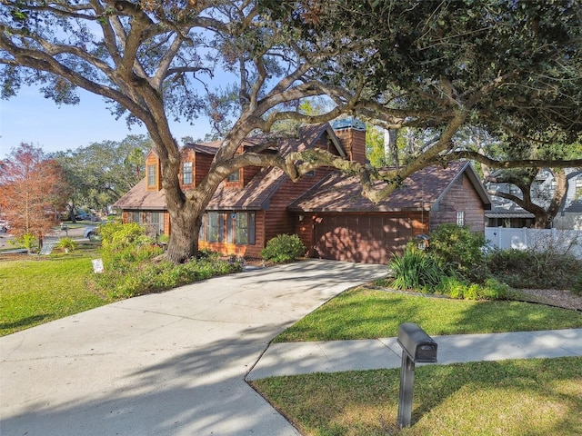 view of front of home with a garage and a front yard