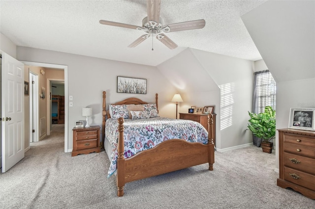 carpeted bedroom with ceiling fan, lofted ceiling, and a textured ceiling