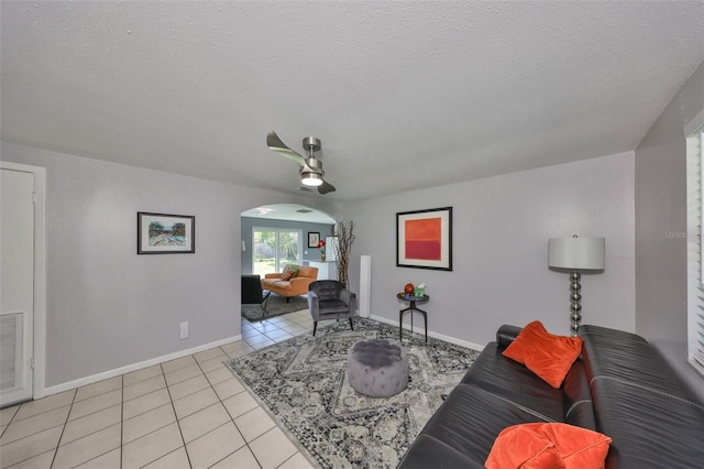 living room with a textured ceiling and light tile patterned floors