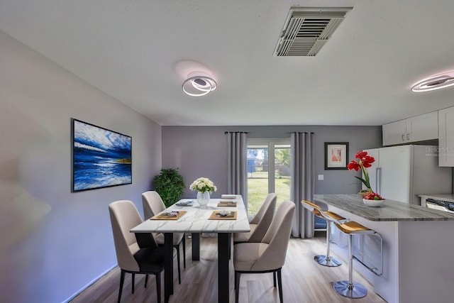 6025 Florida Cir S, Apollo Beach, FL 33572 - dining room with visible vents, light wood finished floors, and baseboards
