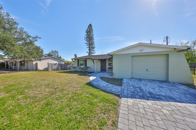 6025 Florida Cir S, Apollo Beach, FL 33572 - ranch-style house featuring a front yard, decorative driveway, fence, an attached garage, and stucco siding