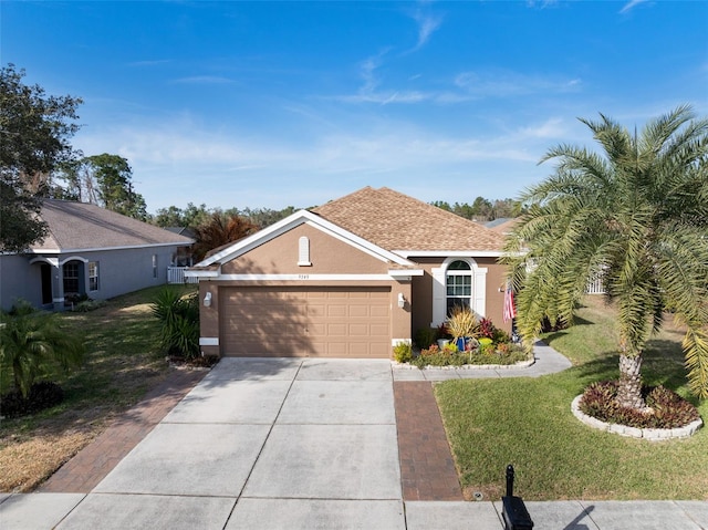 ranch-style home with a garage and a front yard