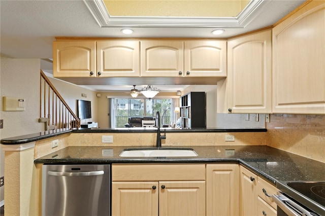 kitchen with light brown cabinetry, sink, dark stone counters, stainless steel dishwasher, and kitchen peninsula