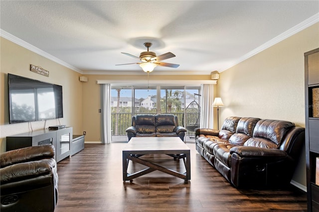 living room with dark hardwood / wood-style flooring, ceiling fan, ornamental molding, and a textured ceiling