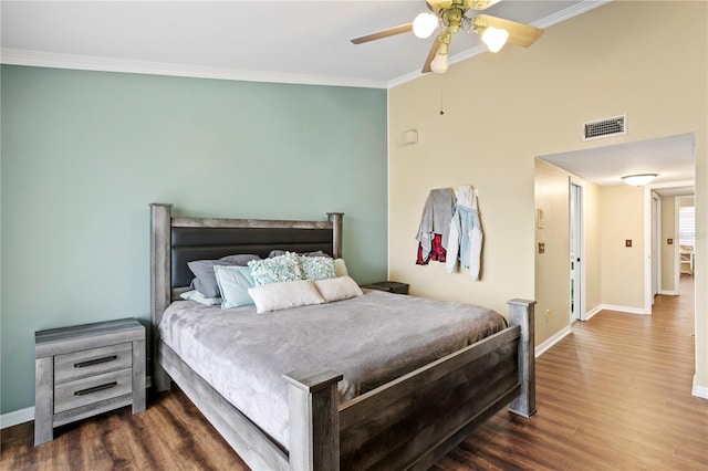 bedroom featuring crown molding, dark hardwood / wood-style floors, and ceiling fan