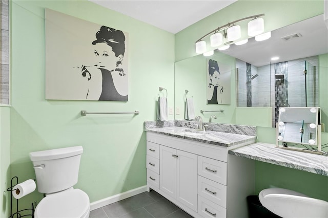 bathroom featuring vanity, tile patterned floors, toilet, and walk in shower