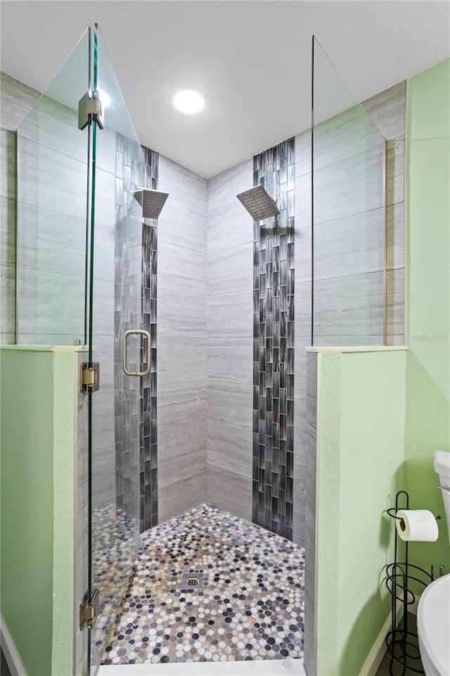 bathroom featuring a shower with door