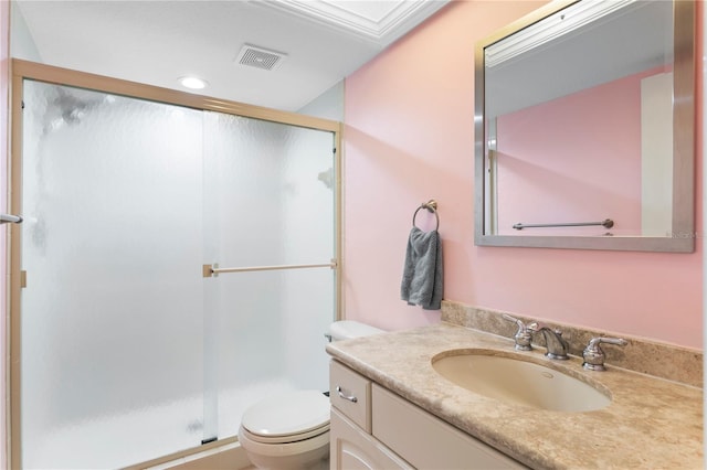 bathroom featuring vanity, an enclosed shower, and toilet