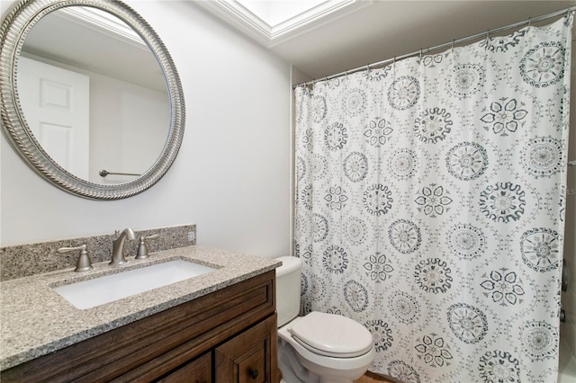 bathroom with vanity, a skylight, toilet, and walk in shower