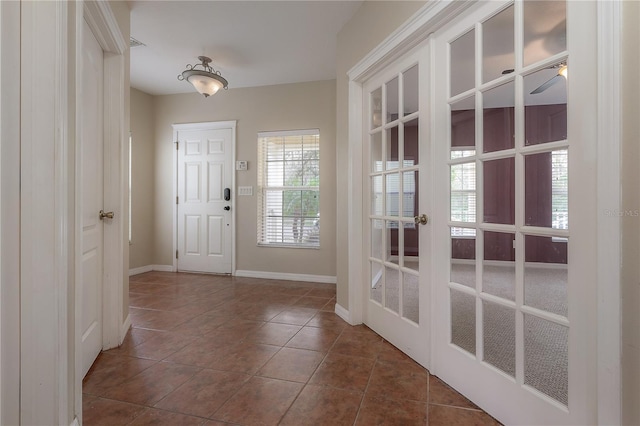 doorway with dark tile patterned flooring and french doors