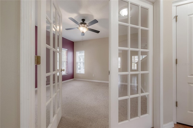 empty room featuring carpet, ceiling fan, and french doors