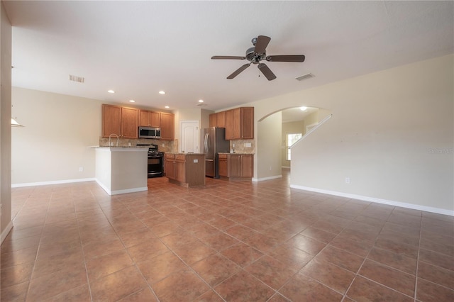 unfurnished living room featuring tile patterned flooring and ceiling fan