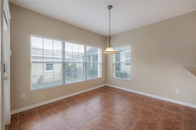 unfurnished dining area featuring tile patterned flooring