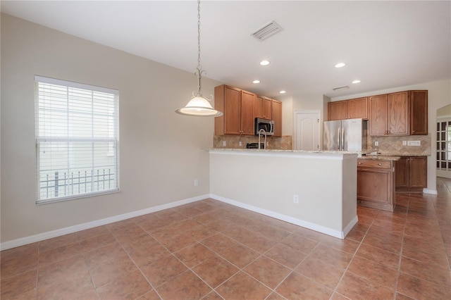 kitchen featuring tasteful backsplash, light tile patterned flooring, appliances with stainless steel finishes, and pendant lighting