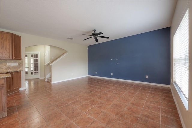 unfurnished living room featuring a wealth of natural light and tile patterned floors