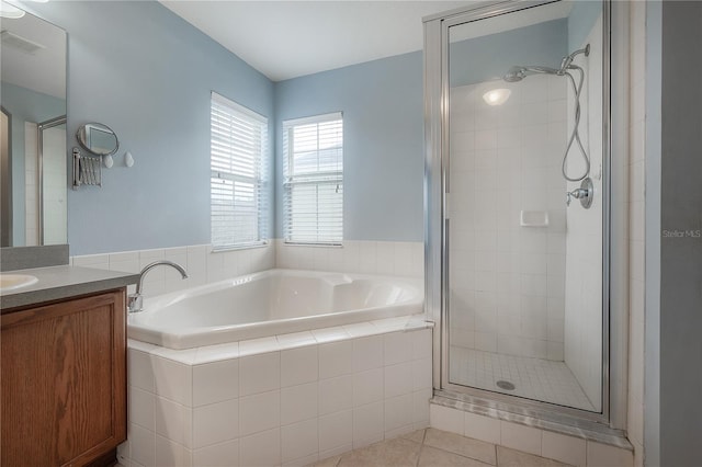 bathroom with tile patterned flooring, vanity, and independent shower and bath