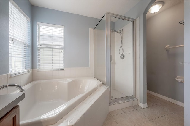 bathroom featuring tile patterned flooring, separate shower and tub, and a wealth of natural light