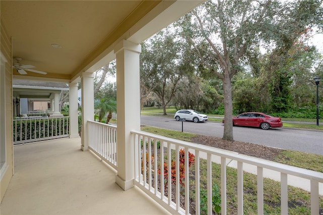 balcony with ceiling fan and a porch