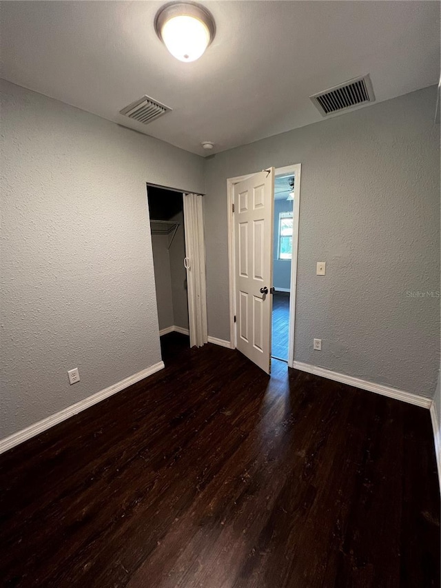 spare room featuring dark hardwood / wood-style floors