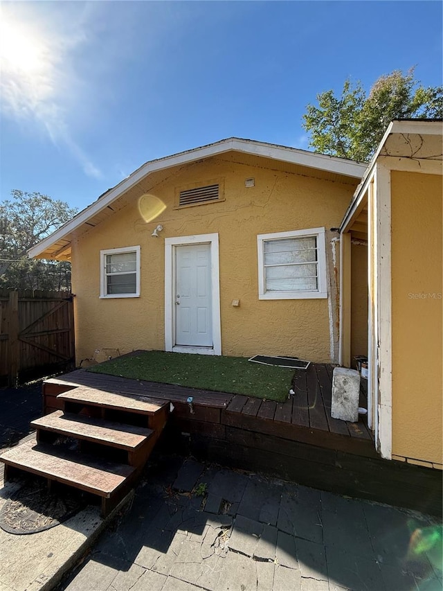 view of front of property featuring a deck and a patio