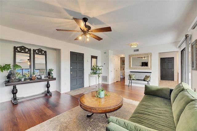 living room featuring wood-type flooring and ceiling fan