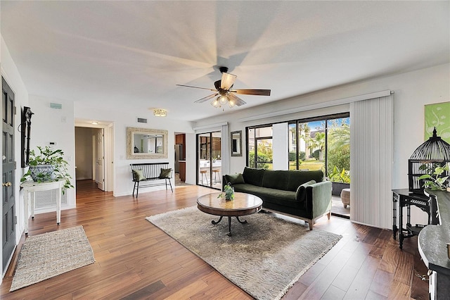 living room with dark hardwood / wood-style floors and ceiling fan