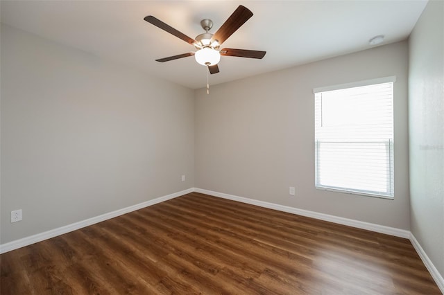 empty room with ceiling fan and dark hardwood / wood-style flooring