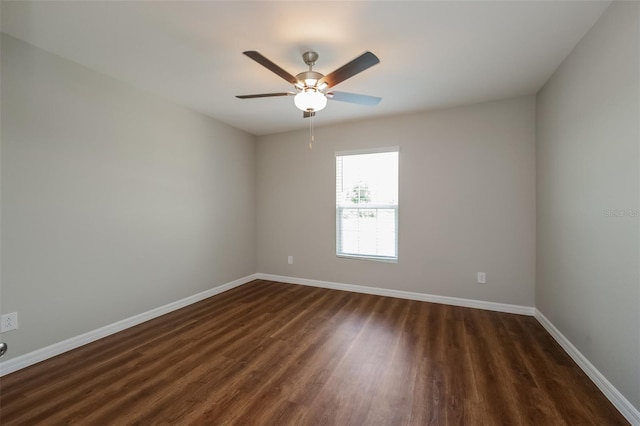 empty room featuring dark wood-type flooring and ceiling fan