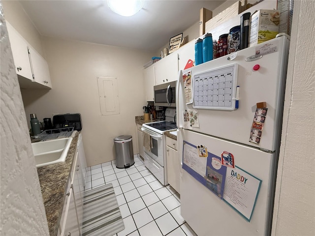 kitchen featuring light tile patterned flooring, white appliances, a sink, white cabinetry, and mail area