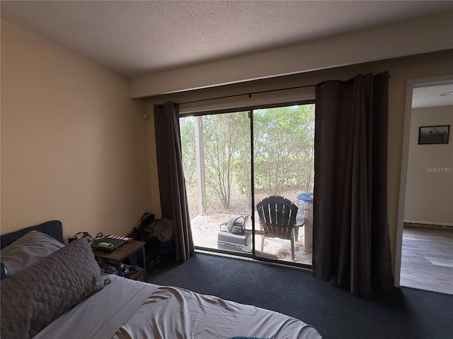 bedroom featuring a textured ceiling and access to outside