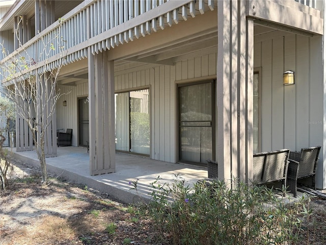 view of exterior entry featuring a patio