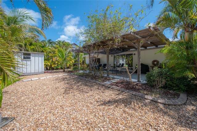 view of yard with a pergola, a shed, and a patio area