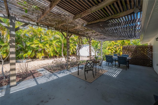 view of patio / terrace featuring a pergola and a shed