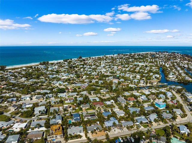 bird's eye view featuring a water view and a beach view