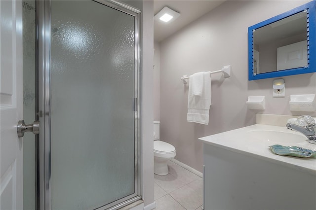 bathroom with vanity, a shower with shower door, tile patterned floors, and toilet