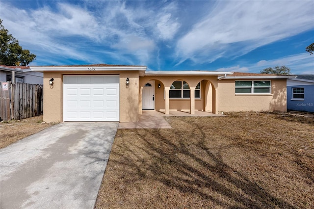 ranch-style home with a garage and a front yard