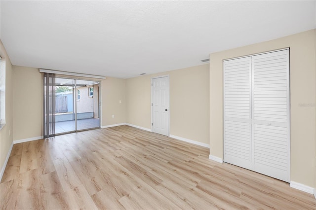 spare room with light hardwood / wood-style floors