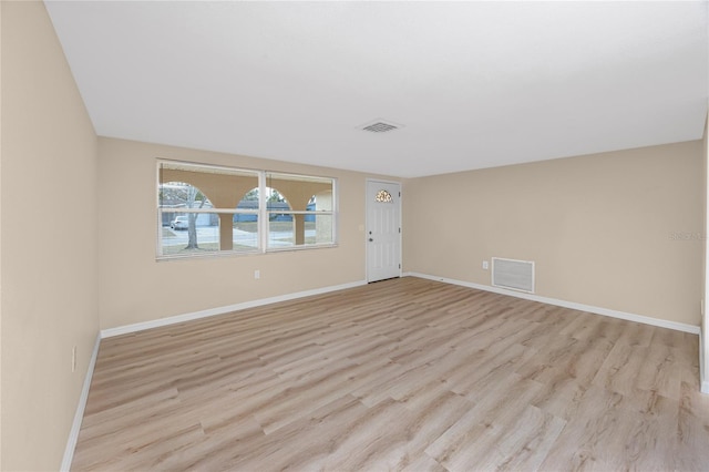 spare room with light wood-type flooring