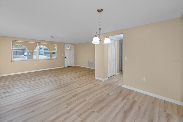 unfurnished dining area featuring light wood-type flooring