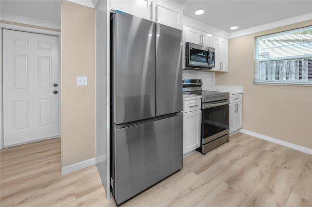 kitchen with stainless steel appliances, light wood-type flooring, and white cabinets