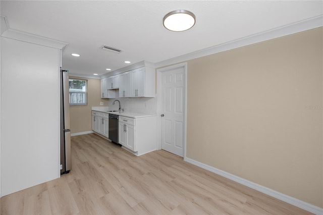 kitchen with white cabinetry, appliances with stainless steel finishes, sink, and light hardwood / wood-style flooring