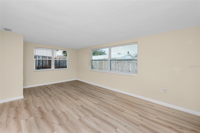 spare room with light wood-type flooring