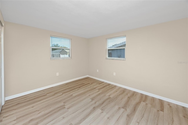 empty room with light hardwood / wood-style flooring