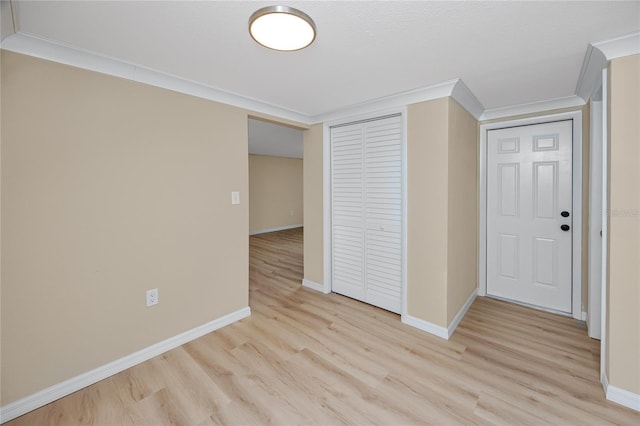 interior space featuring ornamental molding and light hardwood / wood-style floors