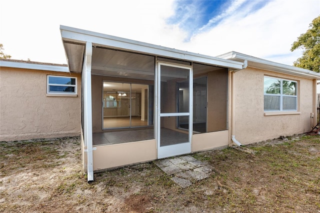 back of house with a sunroom