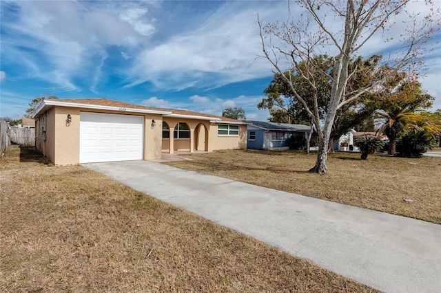 ranch-style house featuring a garage and a front lawn