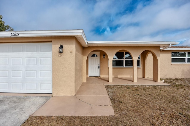 doorway to property with a garage