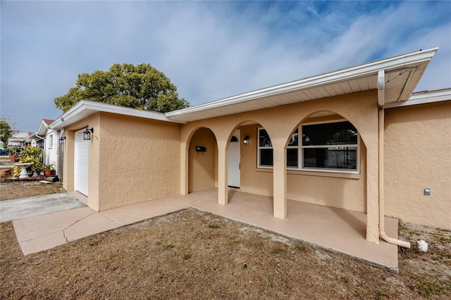 doorway to property with a garage