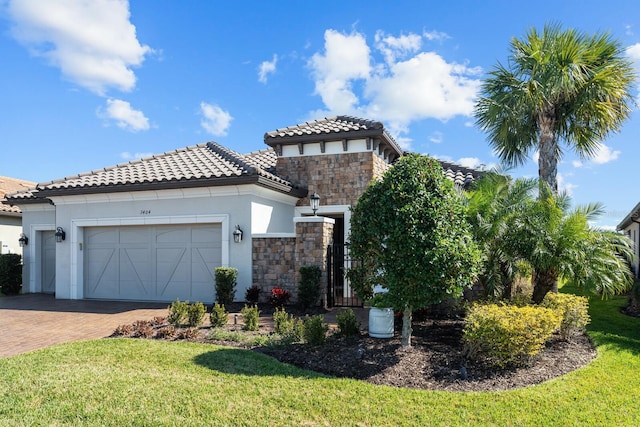 mediterranean / spanish home with a garage and a front yard