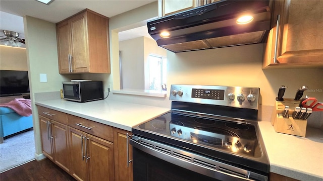 kitchen featuring dark hardwood / wood-style floors and appliances with stainless steel finishes